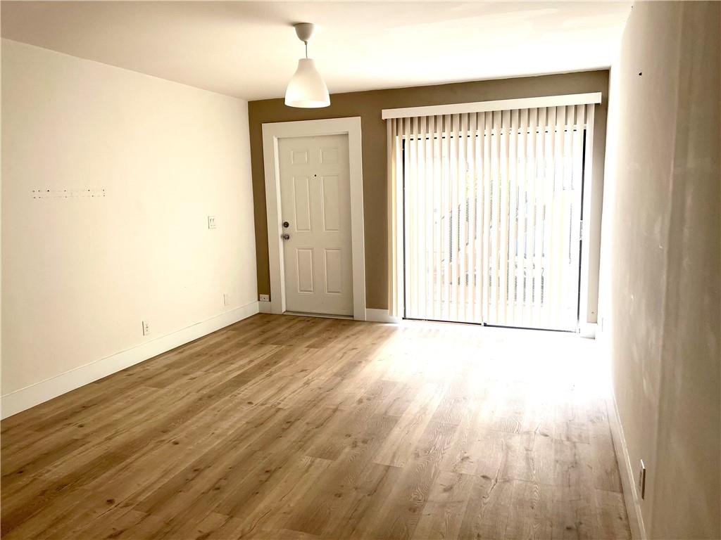 10930 Royal Palm Boulevard, Unit 10930 Coral Springs, FL 33065 - Photo 5 of 11 an empty room with wooden floor and windows