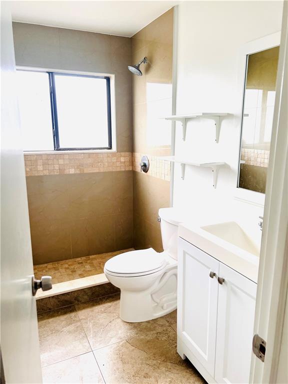 10930 Royal Palm Boulevard, Unit 10930 Coral Springs, FL 33065 - Photo 6 of 11 a bathroom with a toilet a sink and a mirror