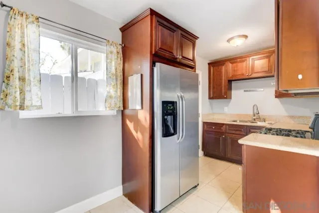 an empty room with wooden floor and a ceiling fan