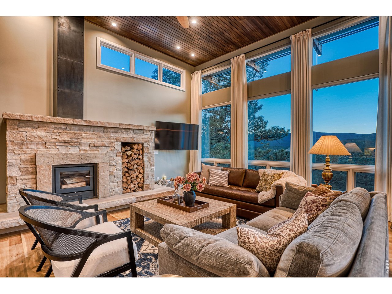 153 Poorman Road Boulder, CO 80302 - Photo 14 of 50 Living room Buff Stone wood fireplace and large windows