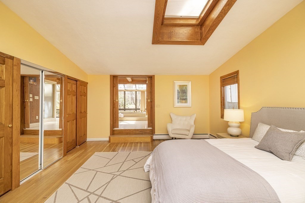 6 Nelson Drive Brookline, MA 02467 - Photo 14 of 42 a spacious bedroom with a bed and wooden floor