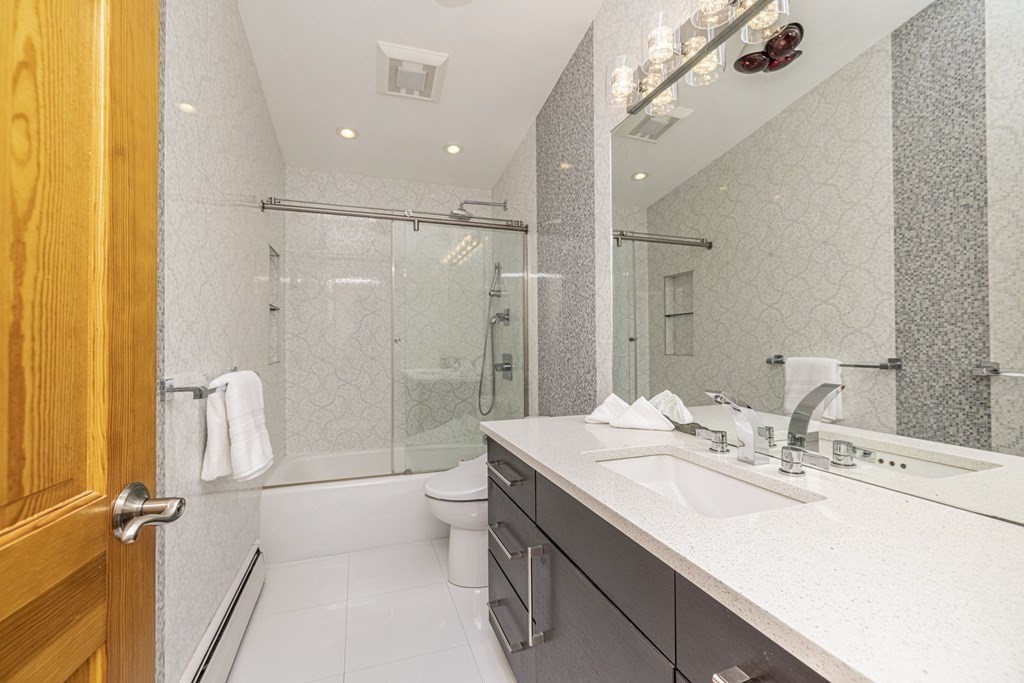 6 Nelson Drive Brookline, MA 02467 - Photo 23 of 42 a bathroom with a double vanity sink toilet mirror and shower