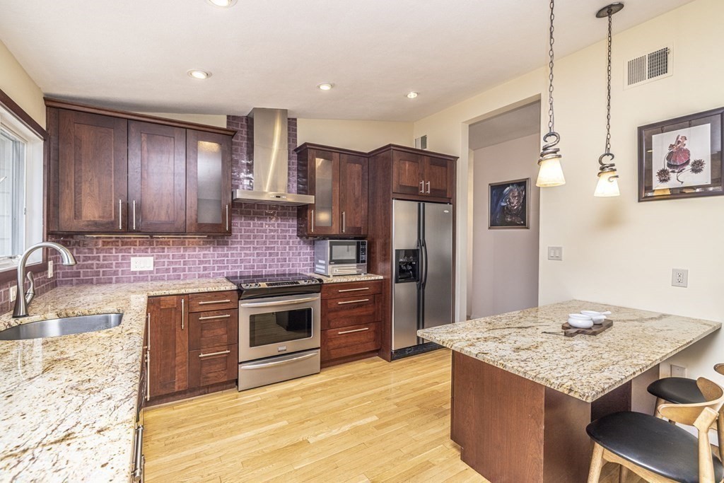 6 Nelson Drive Brookline, MA 02467 - Photo 8 of 42 a kitchen with stainless steel appliances granite countertop a stove refrigerator sink and cabinets