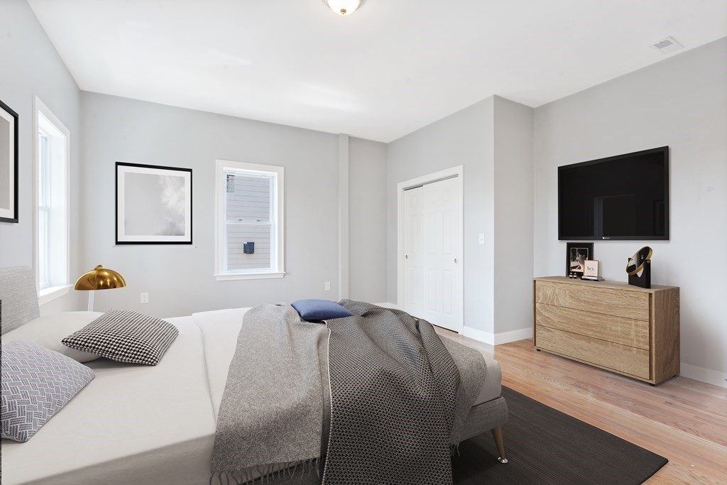9 Wales Street, Unit 2 Boston, MA 02124 - Photo 4 of 15 a bedroom with a bed and a flat screen tv
