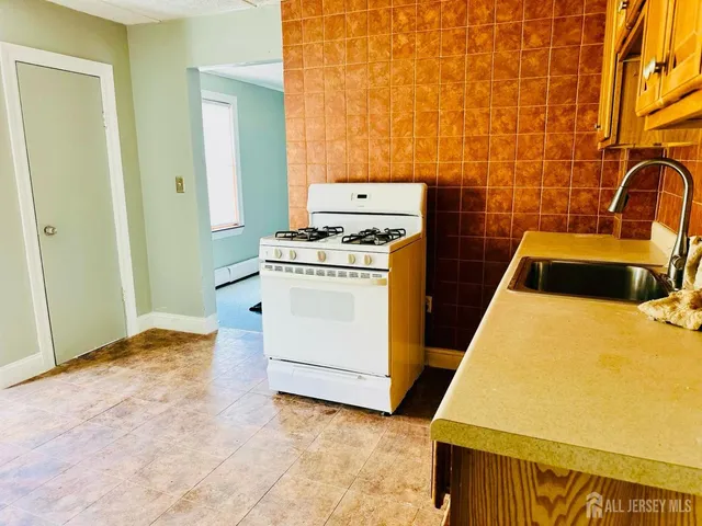 a bedroom with a stove and a table