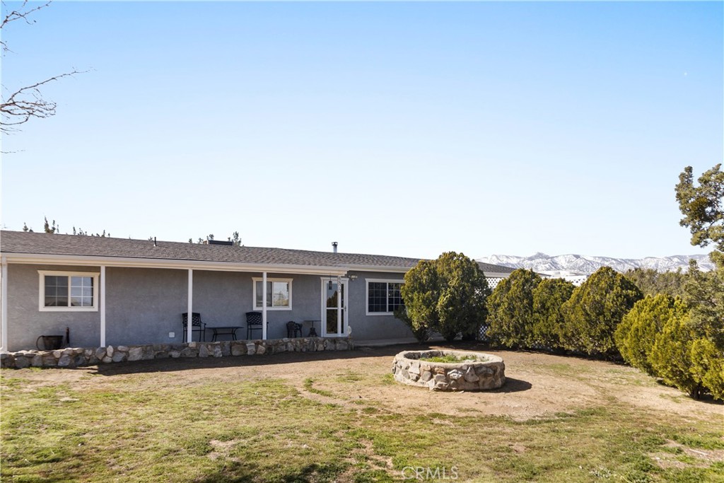 6873 Cambria Road Phelan, CA 92371 - Photo 1 of 1 a front view of a house with a yard