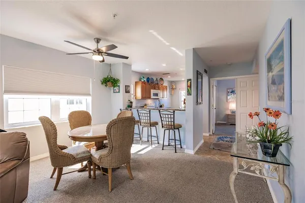 a view of a dining room with furniture and a potted plant