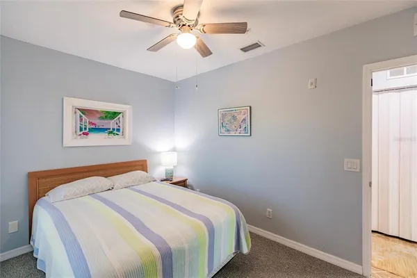 a bedroom with a bed and a painting on the wall