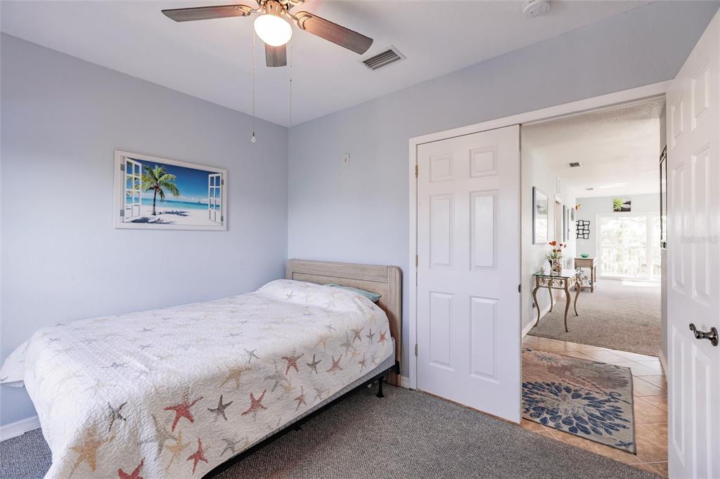 8409 Placida Road, Unit 308 Placida, FL 33946 - Photo 32 of 56 a bedroom with a bed and a chandelier