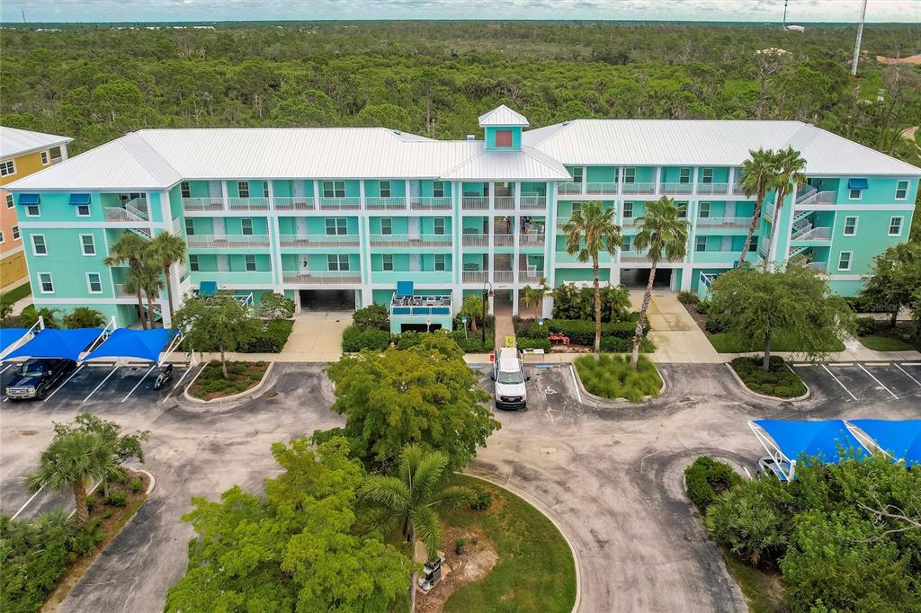 8409 Placida Road, Unit 308 Placida, FL 33946 - Photo 38 of 56 a view of a chair and table under an umbrella