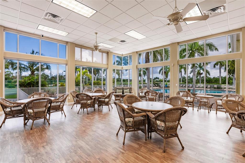 8409 Placida Road, Unit 308 Placida, FL 33946 - Photo 45 of 56 a view of a dining room with furniture large windows and wooden floor
