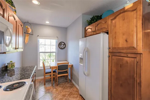 a kitchen with stainless steel appliances granite countertop a refrigerator and a stove