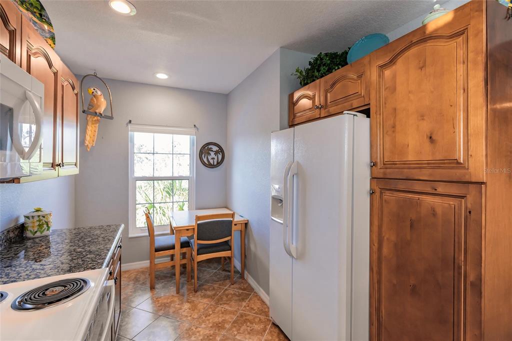 8409 Placida Road, Unit 308 Placida, FL 33946 - Photo 10 of 56 a kitchen with stainless steel appliances granite countertop a refrigerator and a stove