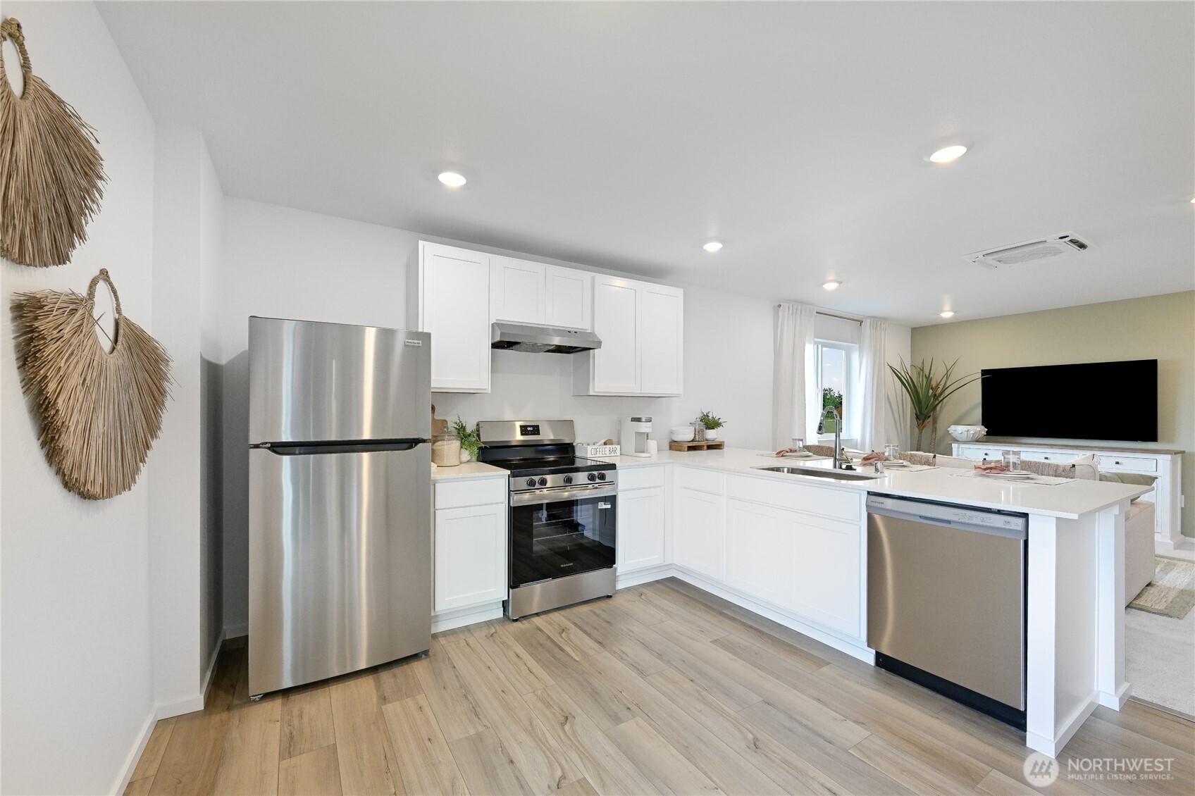 55 Moonshadow Lane Sequim, WA 98382 - Photo 4 of 22 a kitchen with a refrigerator a stove top oven a sink and a microwave
