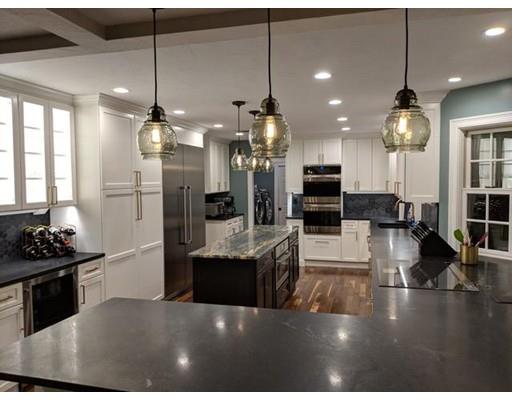119 Robinson Road Boxborough, MA 01719 - Photo 2 of 27 a kitchen with stainless steel appliances kitchen island granite countertop a stove and a view of living room with windows