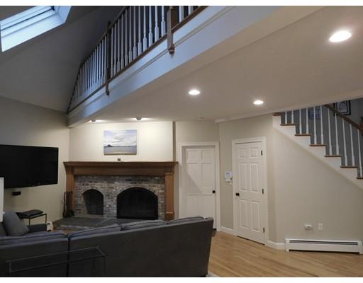 119 Robinson Road Boxborough, MA 01719 - Photo 9 of 27 a living room with a fireplace and a flat screen tv