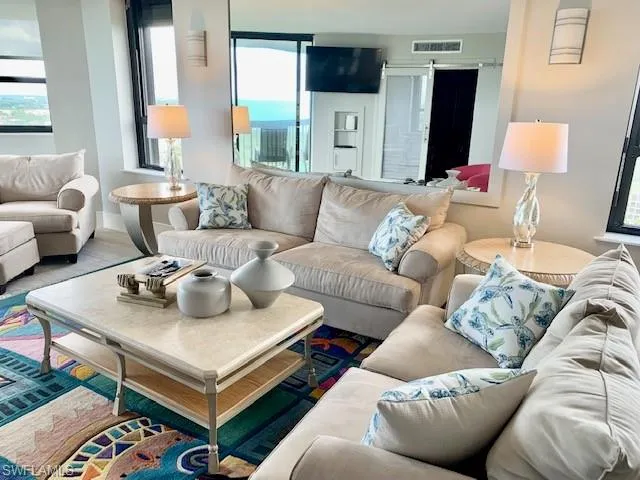 a living room with furniture and a lamp