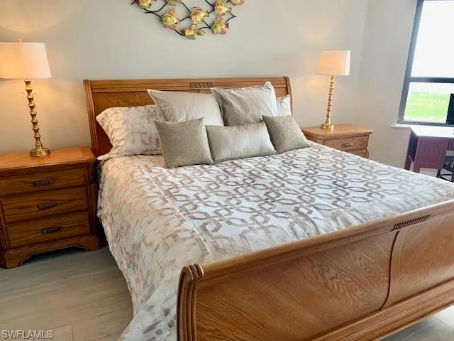 a bed sitting in a bedroom with a lamp