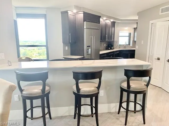 a kitchen with a dining table chairs and window
