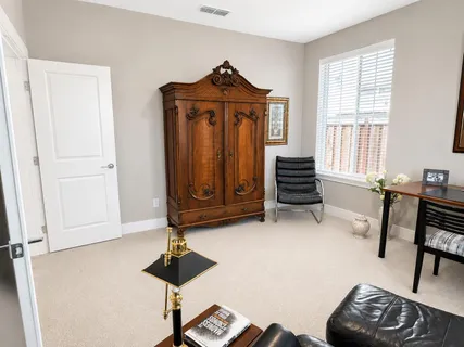 a view of a livingroom with furniture and a window