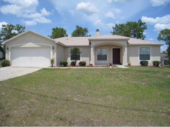 7040 Hemlock Road Ocala, FL 34472 - Photo 1 of 1 a front view of a house with a yard