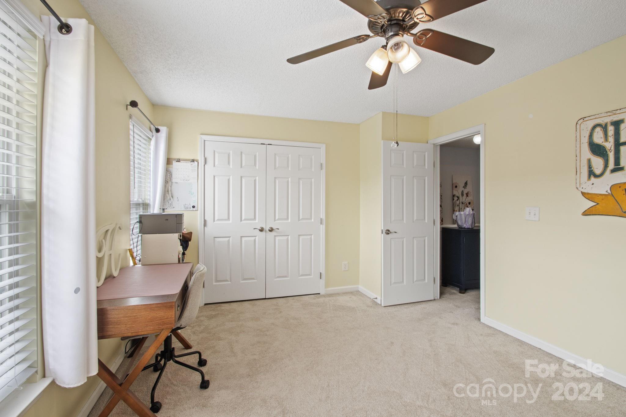 6031 Creft Circle Indian Trail, NC 28079 - Photo 12 of 28 a living room with furniture and a chandelier fan