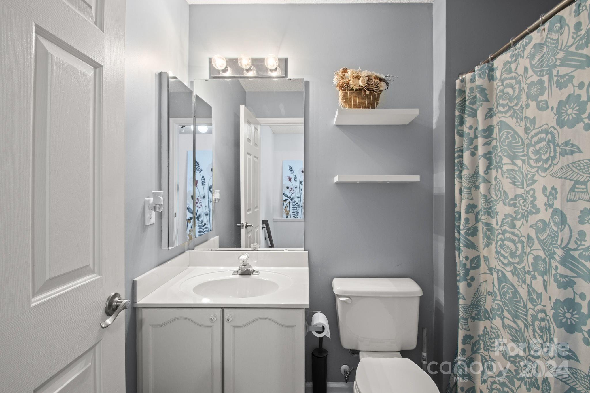 6031 Creft Circle Indian Trail, NC 28079 - Photo 13 of 28 a bathroom with a toilet sink and mirror
