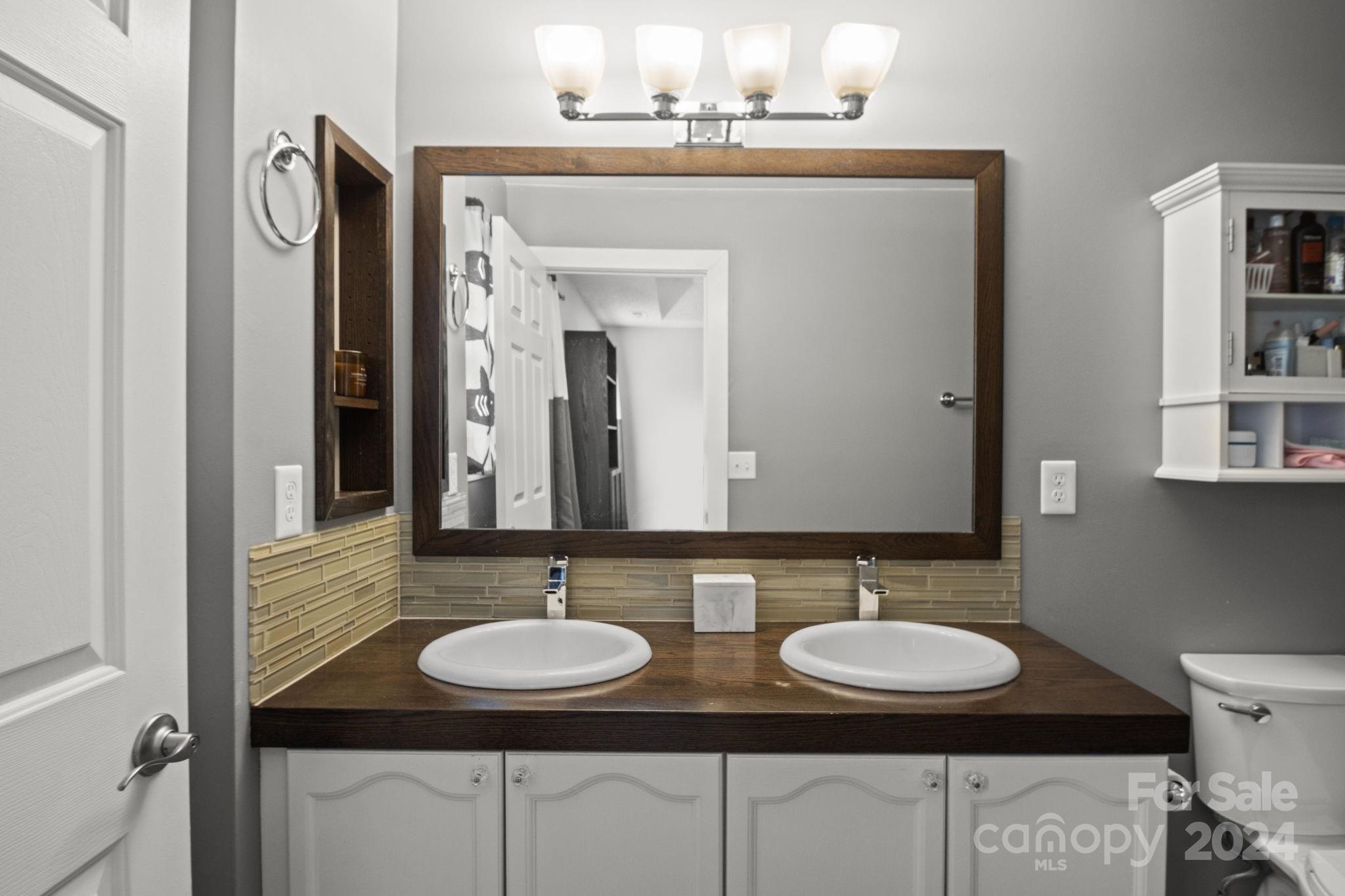 6031 Creft Circle Indian Trail, NC 28079 - Photo 17 of 28 a bathroom with a granite countertop sink and a mirror
