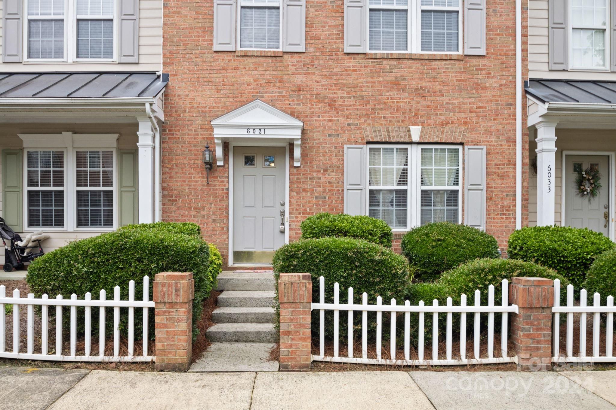 6031 Creft Circle Indian Trail, NC 28079 - Photo 2 of 28 a front view of a house with a garden