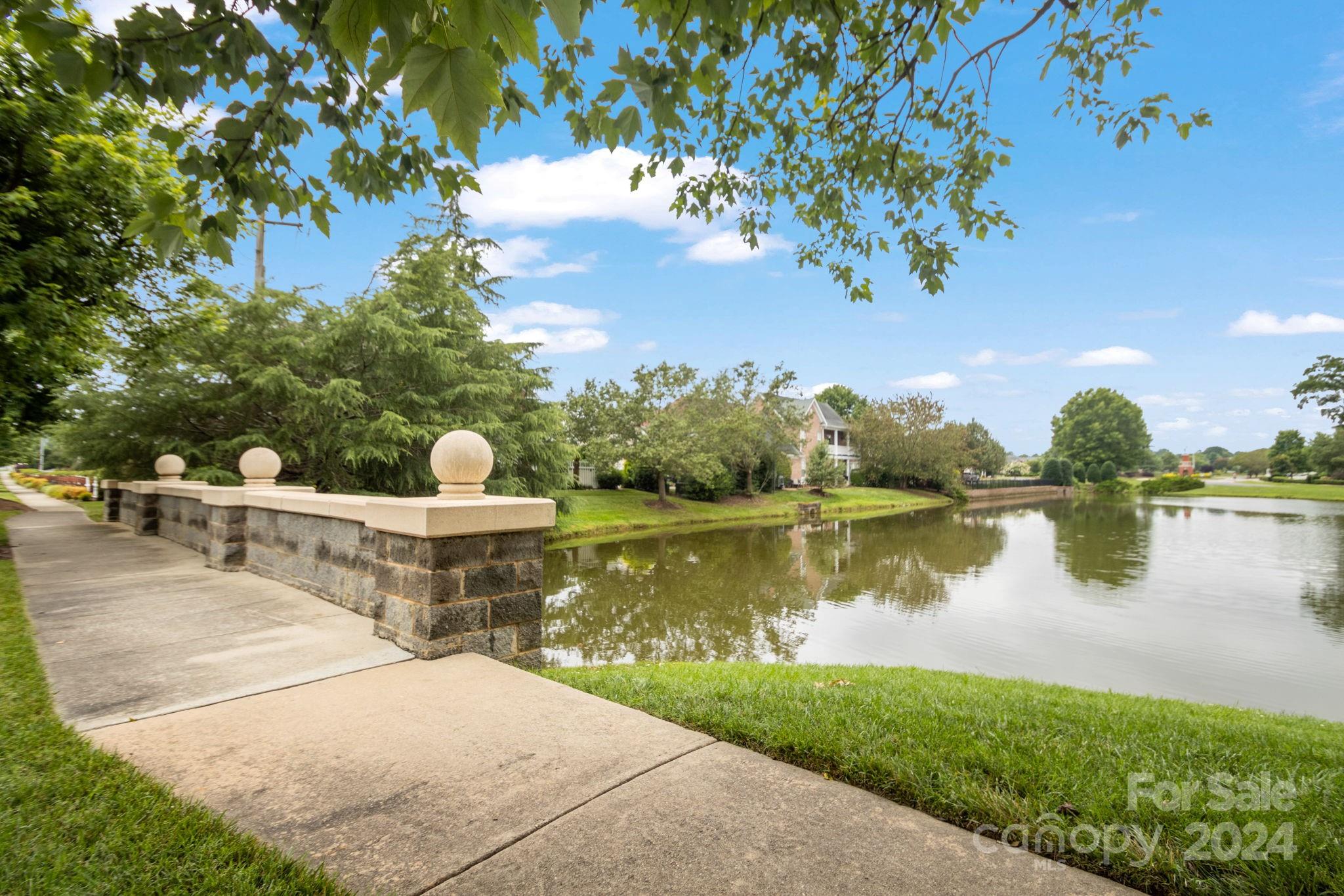 6031 Creft Circle Indian Trail, NC 28079 - Photo 27 of 28 a view of a lake with a garden