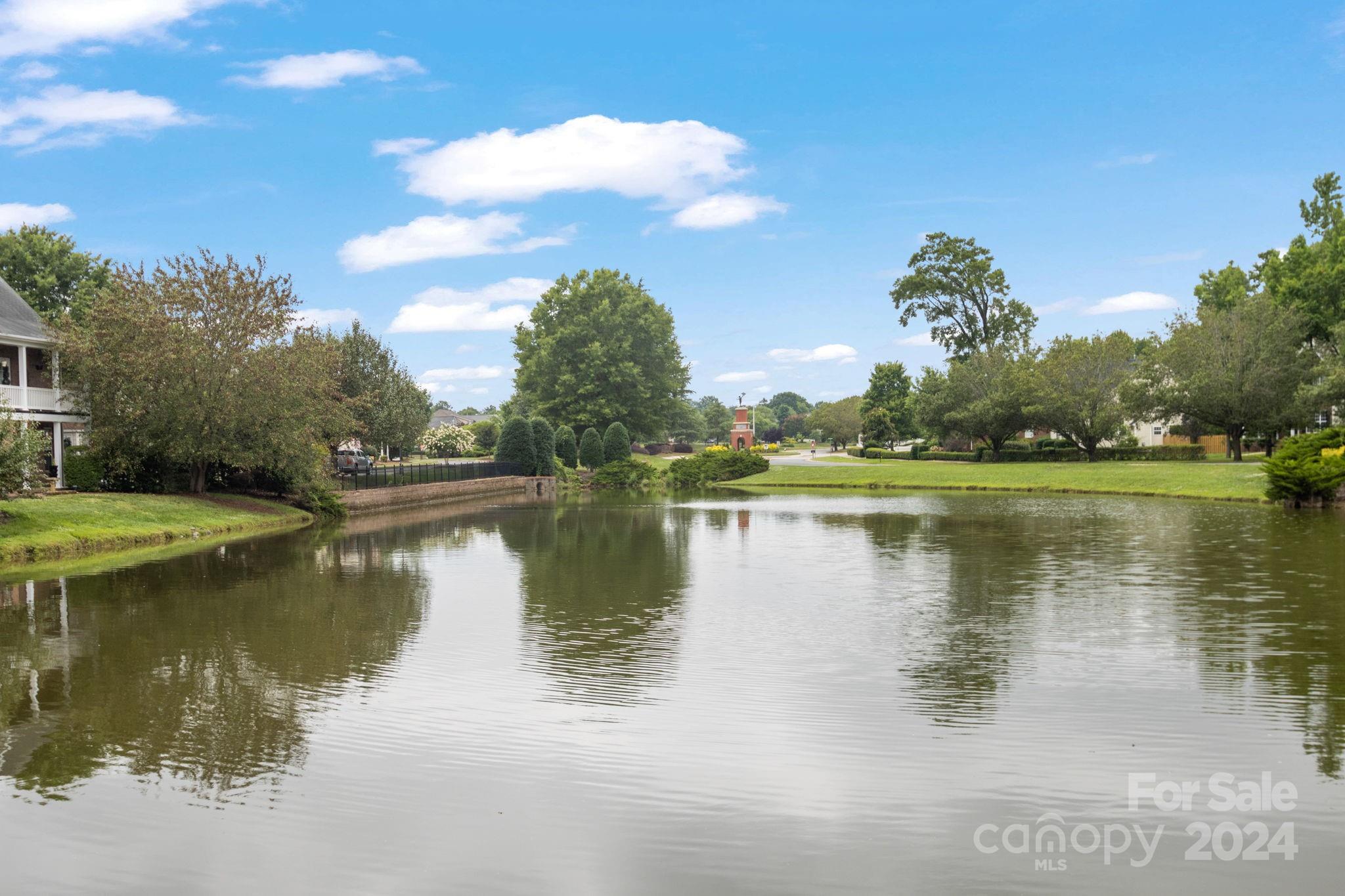 6031 Creft Circle Indian Trail, NC 28079 - Photo 28 of 28 a view of a lake with houses in the background