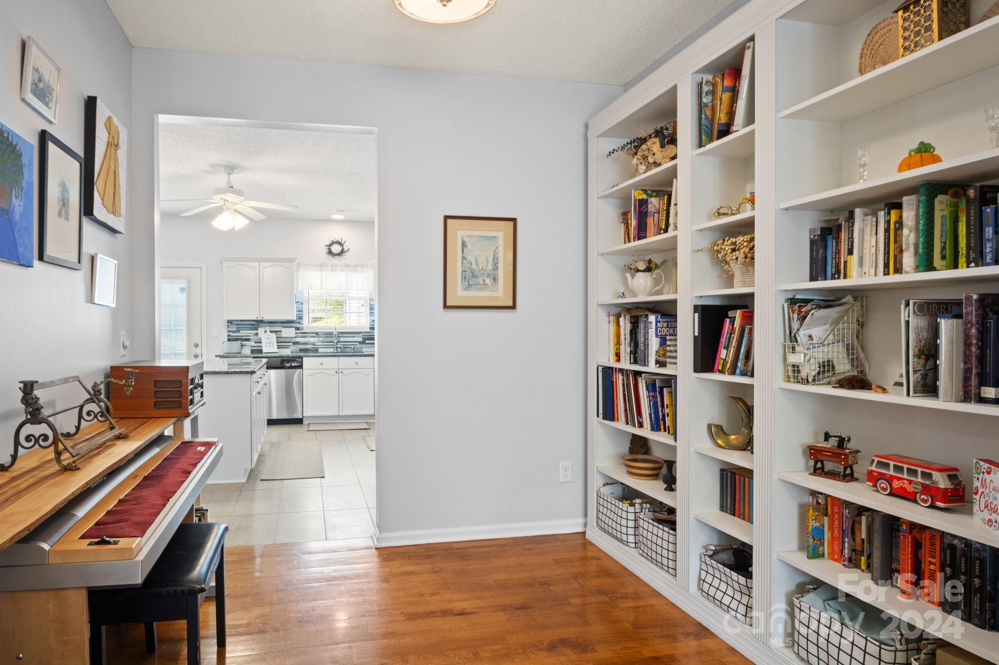 6031 Creft Circle Indian Trail, NC 28079 - Photo 6 of 28 a living room with furniture and a book shelf