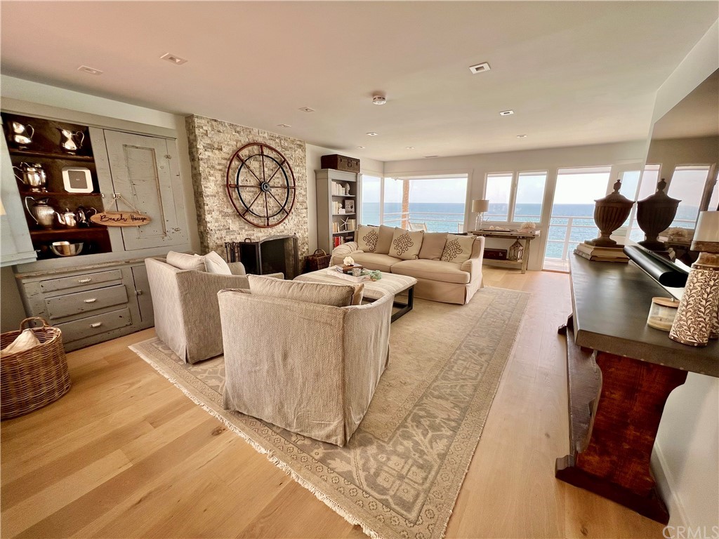 7 Camel Point Drive Laguna Beach, CA 92651 - Photo 14 of 48 a living room with furniture a large window and wooden floor