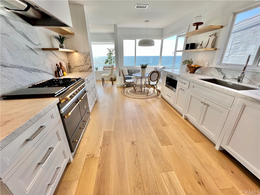 7 Camel Point Drive Laguna Beach, CA 92651 - Photo 19 of 48 a kitchen with stainless steel appliances a stove a sink and a refrigerator
