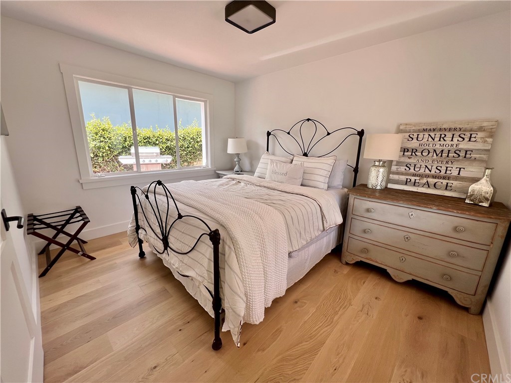 7 Camel Point Drive Laguna Beach, CA 92651 - Photo 25 of 48 a bedroom with a bed a dresser and window