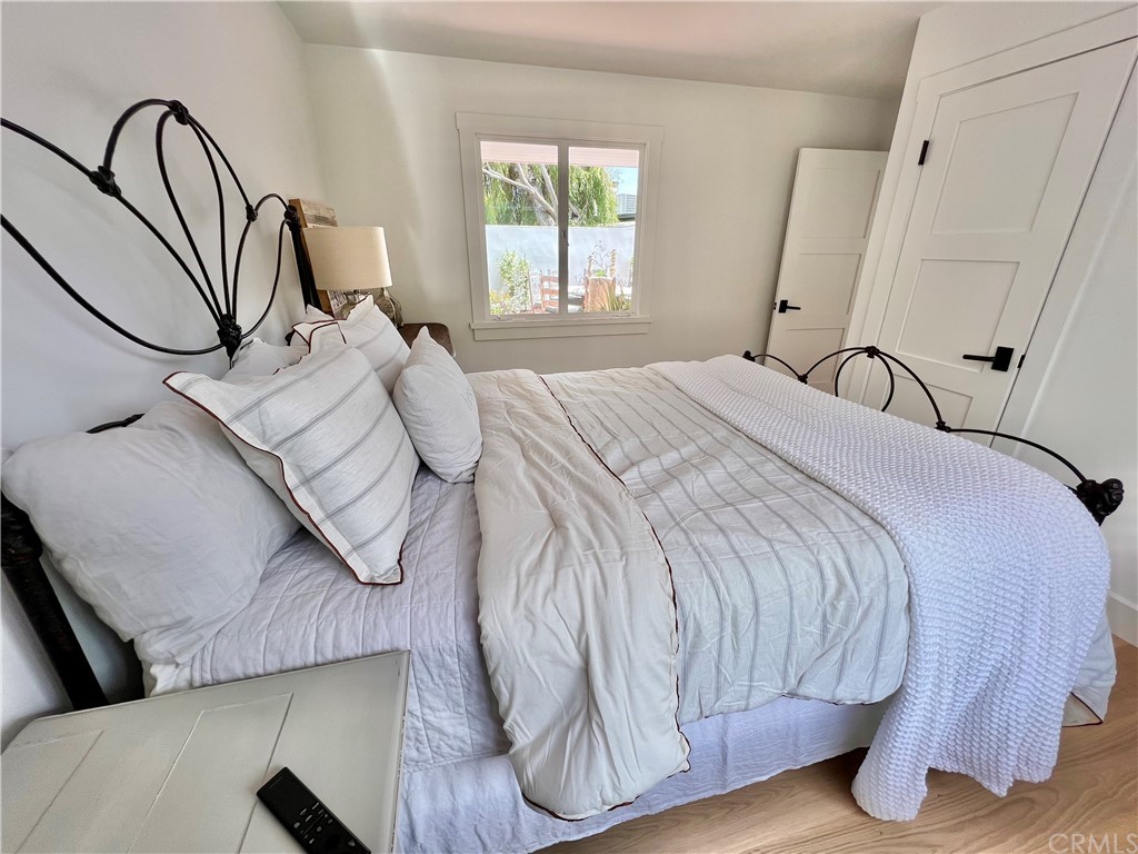 7 Camel Point Drive Laguna Beach, CA 92651 - Photo 26 of 48 a bedroom with a bed and a large mirror on the dresser