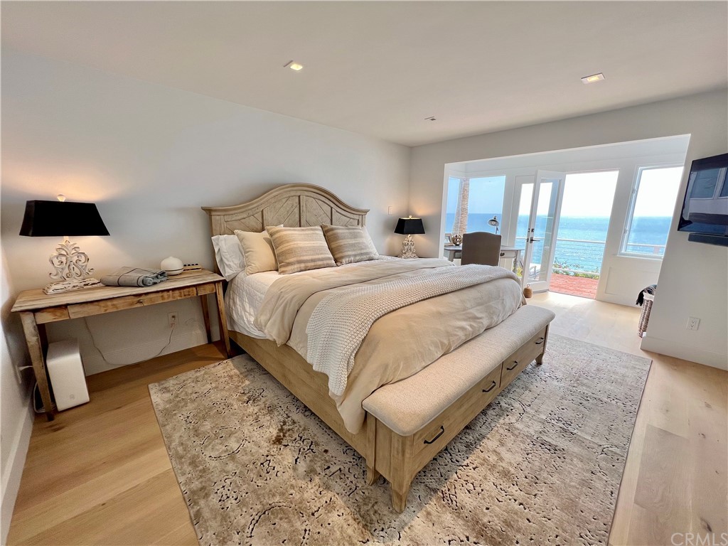 7 Camel Point Drive Laguna Beach, CA 92651 - Photo 30 of 48 a bedroom with a bed and large window