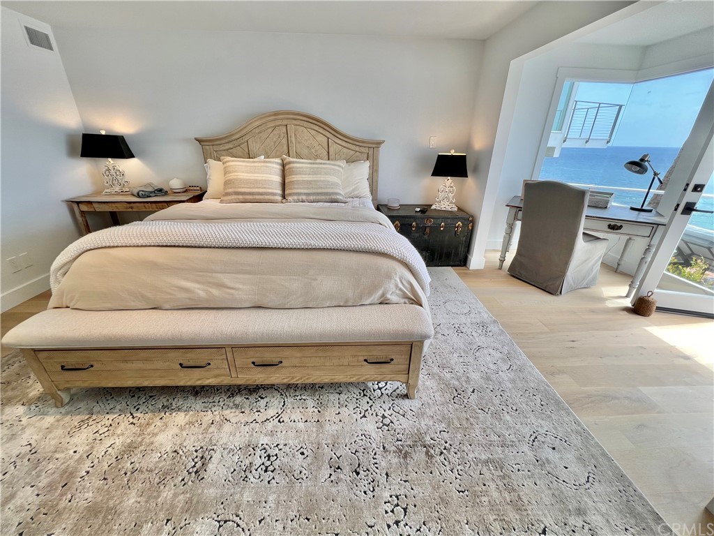 7 Camel Point Drive Laguna Beach, CA 92651 - Photo 31 of 48 a bedroom with a bed and a mirror on the dresser