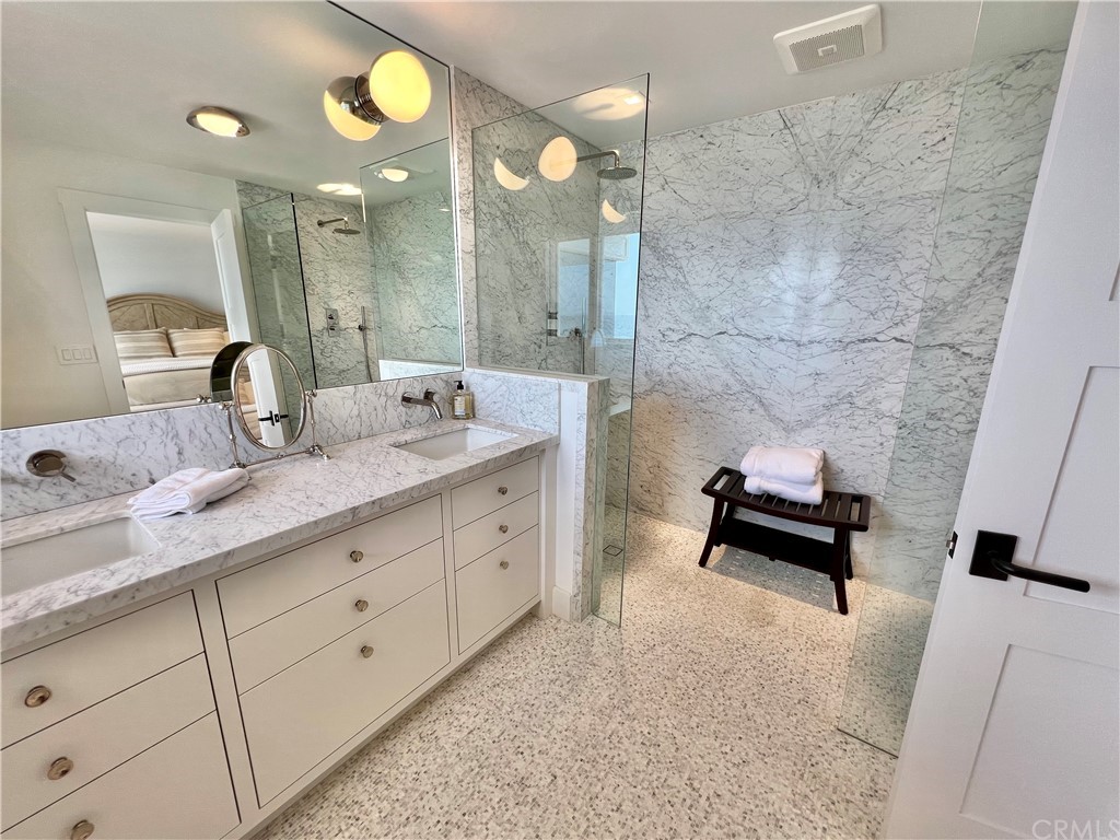 7 Camel Point Drive Laguna Beach, CA 92651 - Photo 34 of 48 a spacious bathroom with a granite countertop sink a toilet a mirror and shower