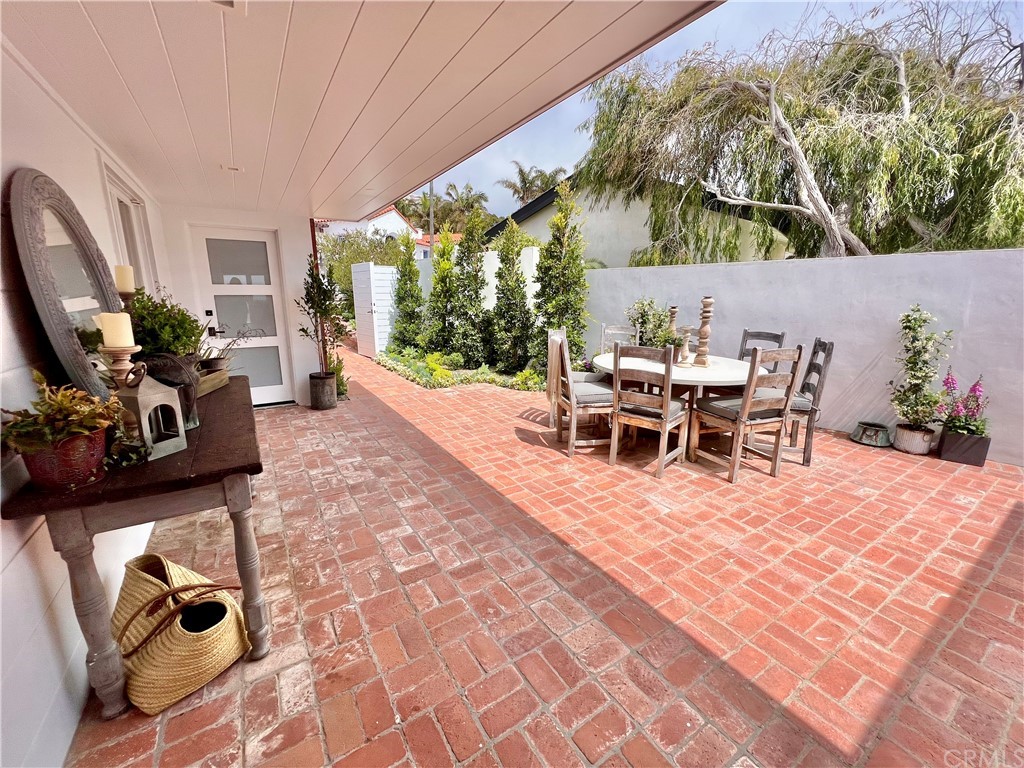 7 Camel Point Drive Laguna Beach, CA 92651 - Photo 10 of 48 a view of a patio with table and chairs potted plants with wooden floor