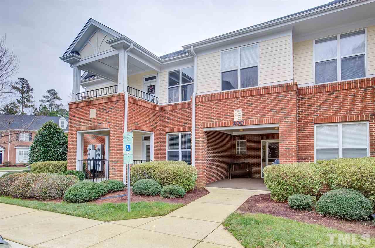 201 West Savannah Ridge Road, Unit 201 Holly Springs, NC 27540 - Photo 1 of 30 front view of a brick house with a yard