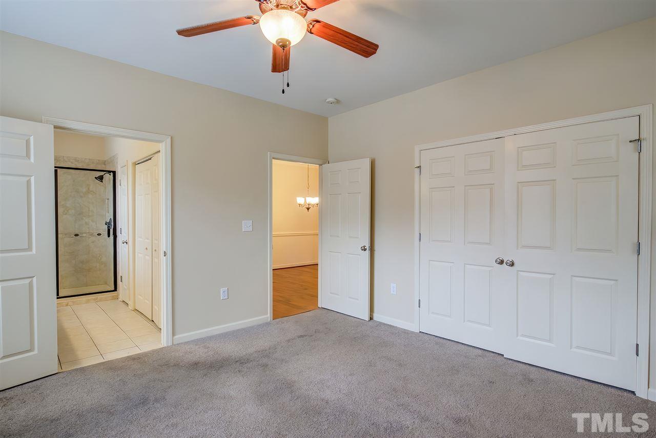 201 West Savannah Ridge Road, Unit 201 Holly Springs, NC 27540 - Photo 22 of 30 an empty room with closet and a chandelier fan