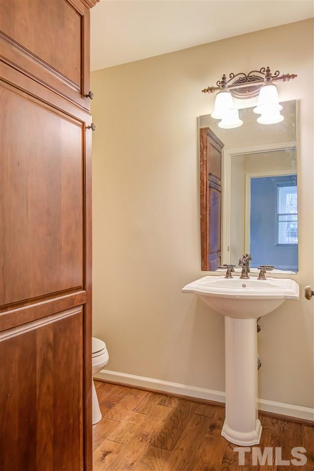 201 West Savannah Ridge Road, Unit 201 Holly Springs, NC 27540 - Photo 27 of 30 a bathroom with a sink and mirror