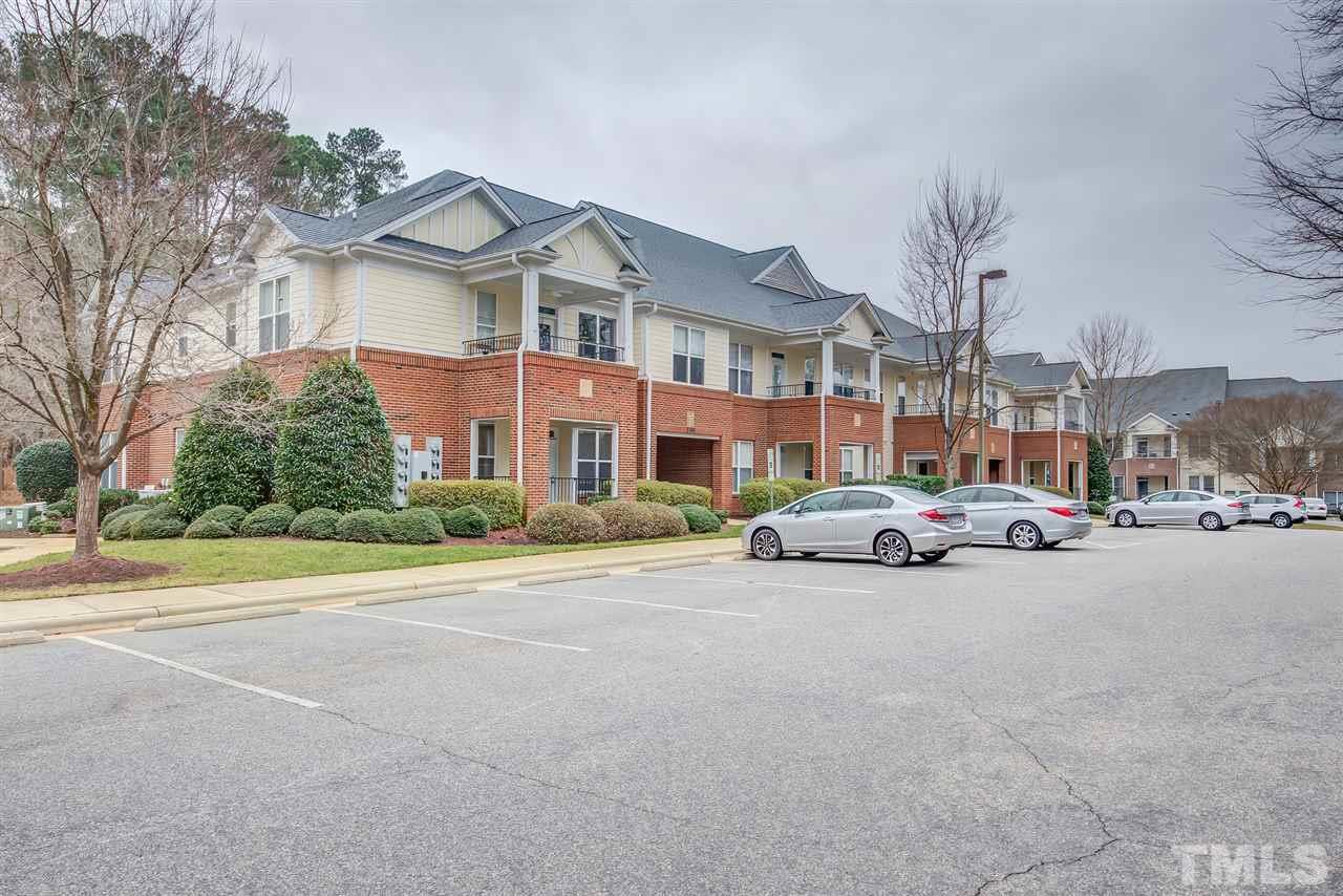 201 West Savannah Ridge Road, Unit 201 Holly Springs, NC 27540 - Photo 29 of 30 a car parked in front of a white house