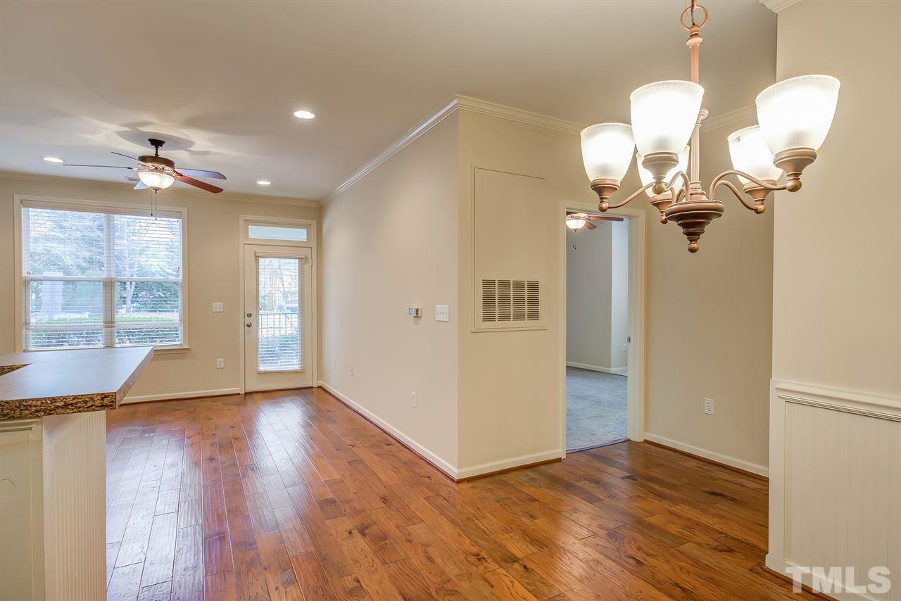 201 West Savannah Ridge Road, Unit 201 Holly Springs, NC 27540 - Photo 9 of 30 a view of an empty room with wooden floor and a window