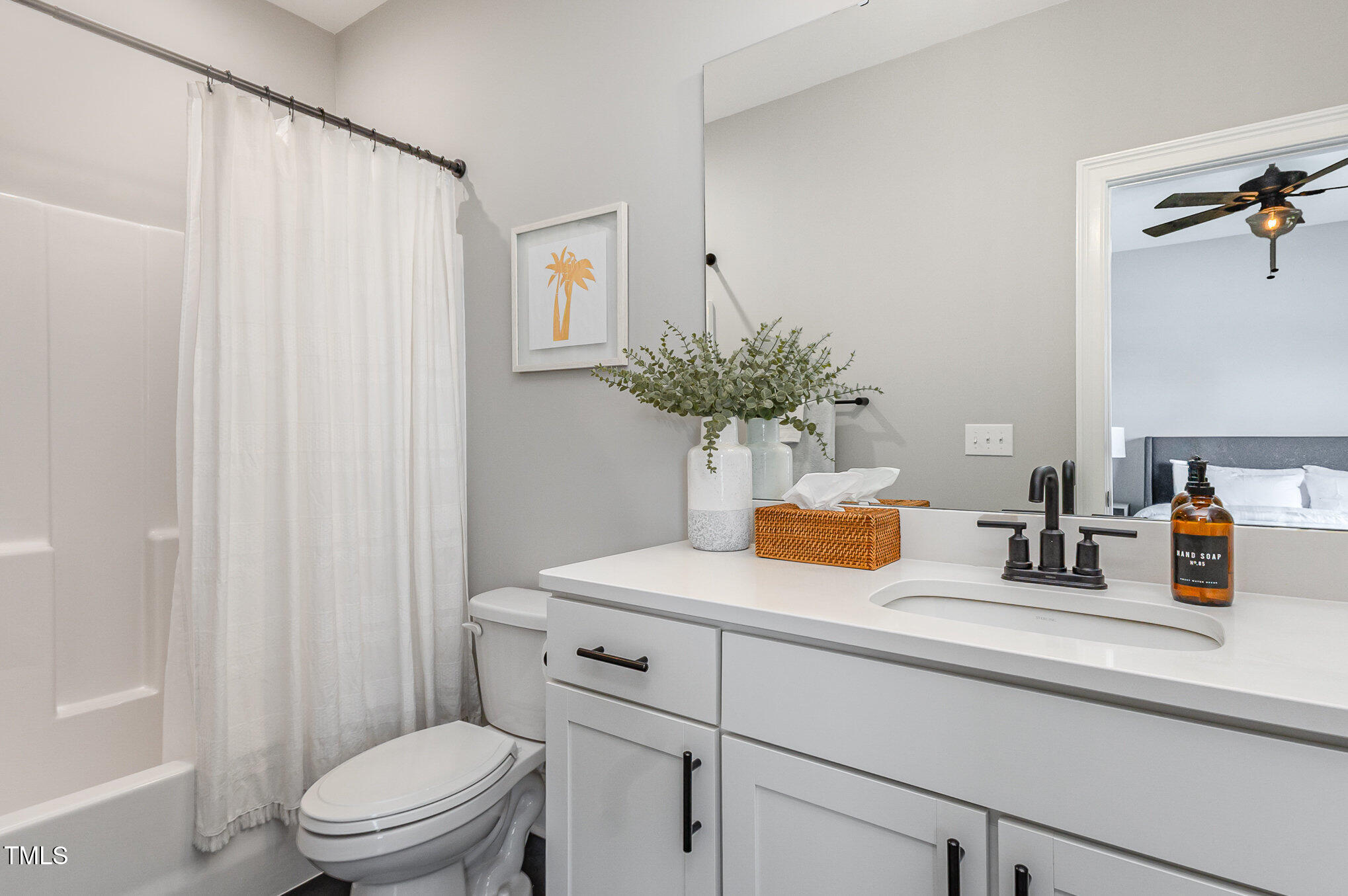 4404 Buckley Drive Apex, NC 27539 - Photo 52 of 79 a bathroom with a sink a toilet and shower curtain