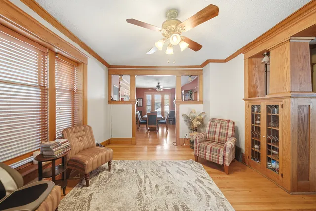a living room with furniture fireplace and a large window