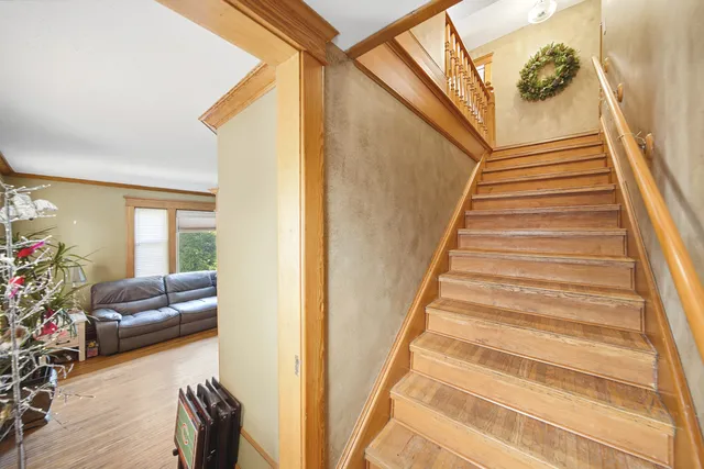 a view of entryway and hall with wooden floor