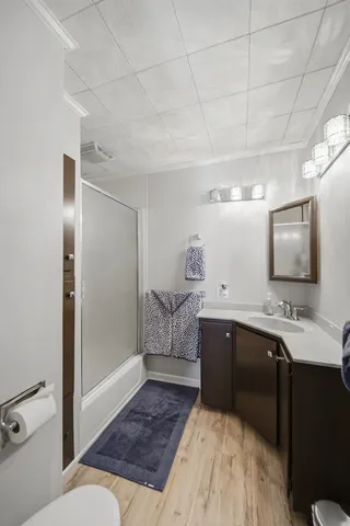a spacious bathroom with a double vanity sink a mirror and bathtub