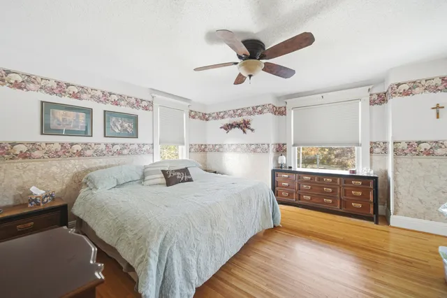 a bedroom with a large bed and a chandelier